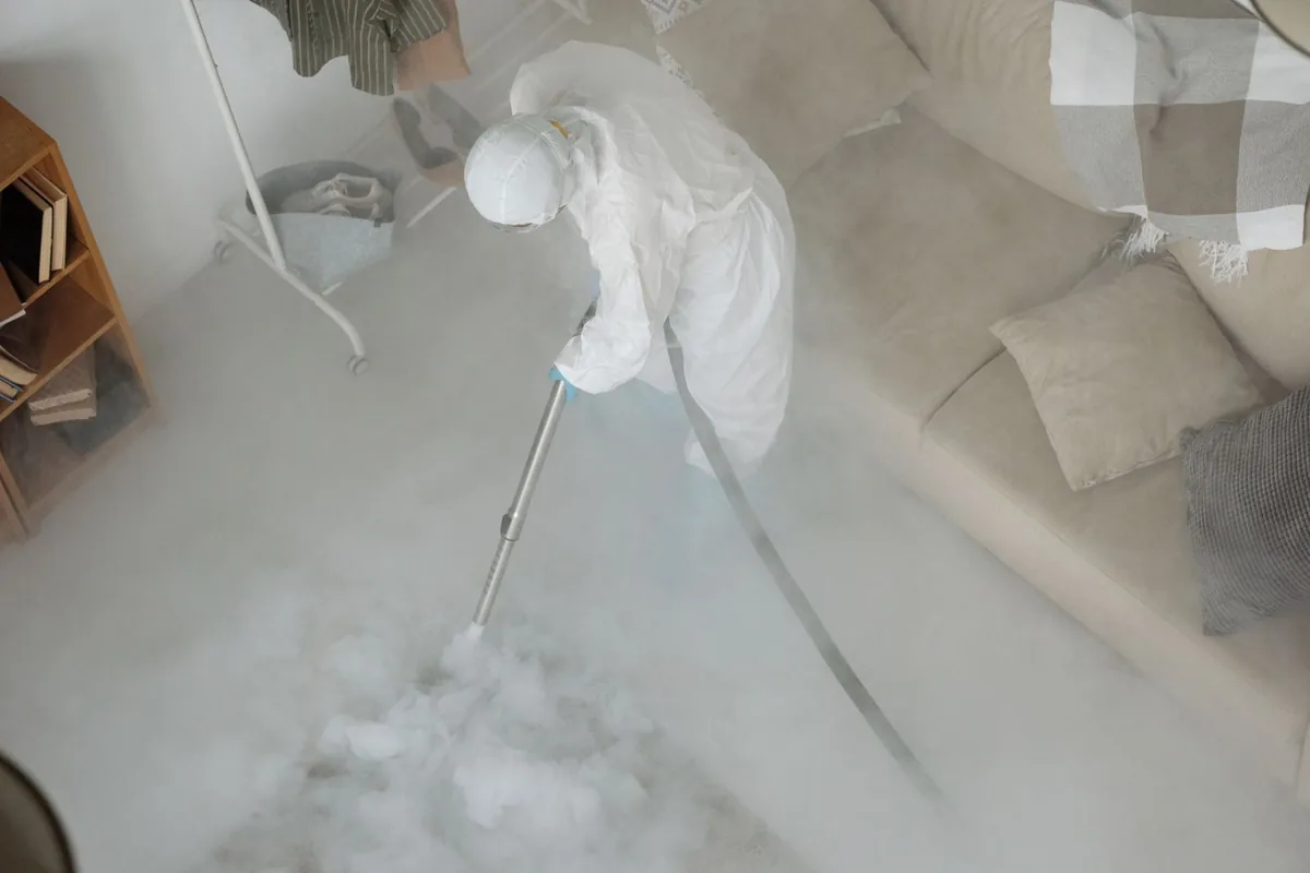Biohazard cleanup technician in protective equipment, Grundy Center, IA
